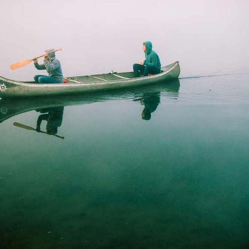Happy friends sharing shisha in a garden bar